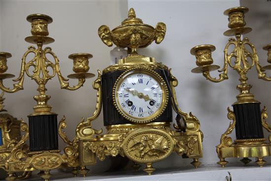 A late 19th century French bronze and ormolu clock garniture, 11.5in.